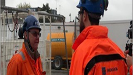 Picture of two workers on site having a conversation