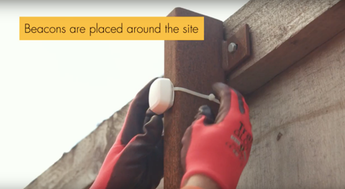 Picture of  two hands  installing a beacon around a site