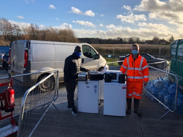 A picture of two people donating white goods 