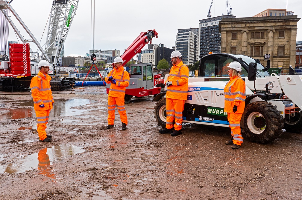 A picture of 4 workers in PPE onsite 