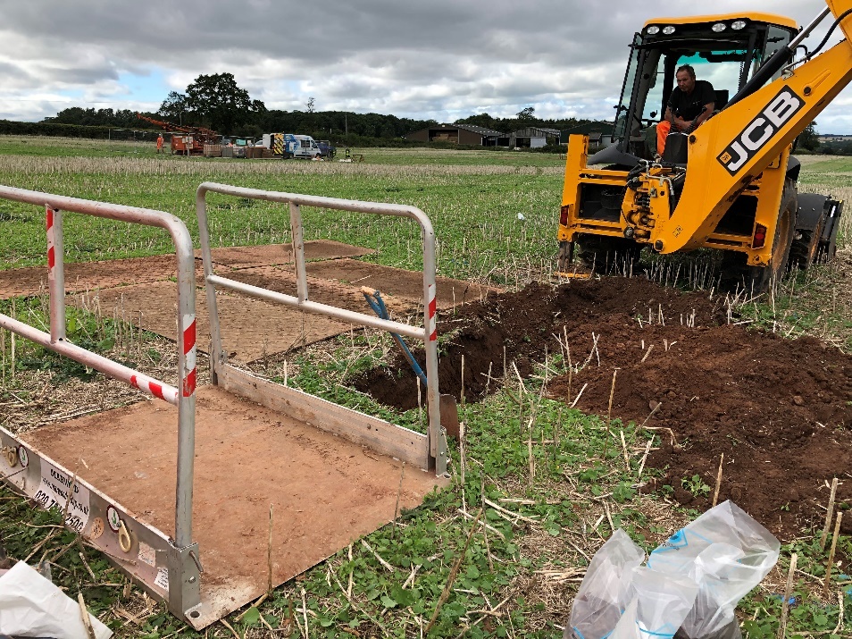 Picture of a mechanical excavator excavating a trial pit 