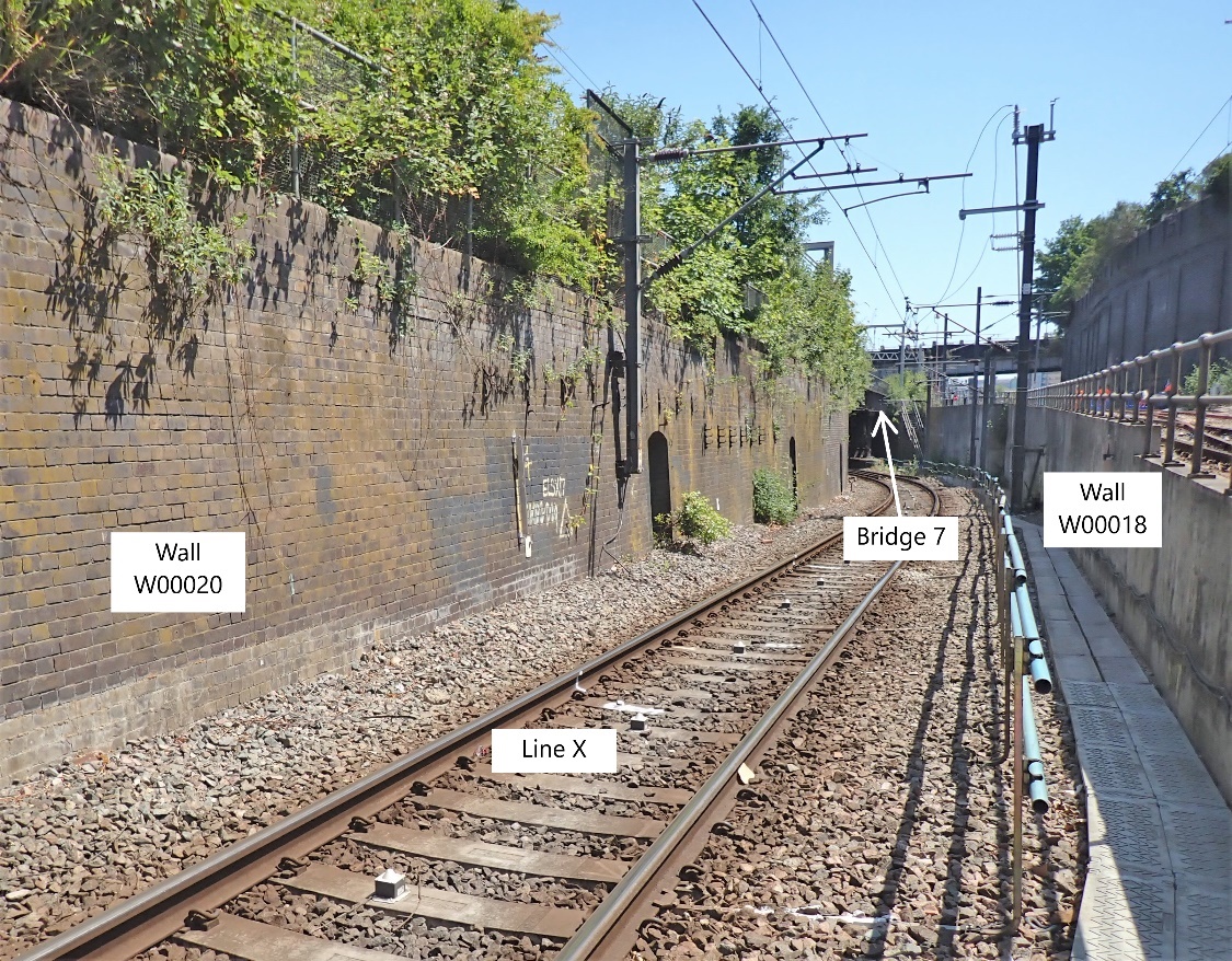 A picture containing text, track, train, sky

Description automatically generated