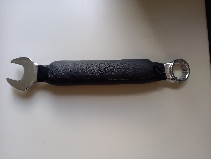A close-up of a spanner with rubberised  sleeve