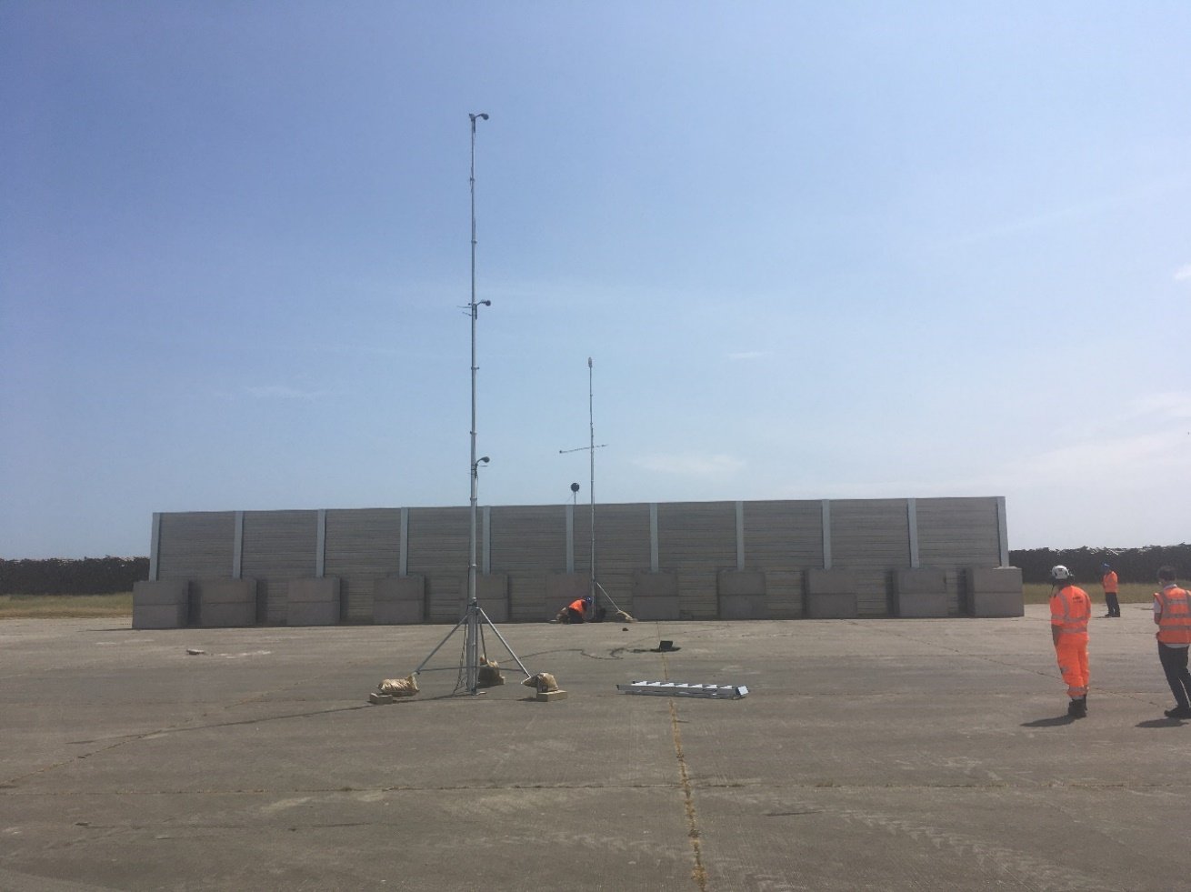 Picture of workers at test barrier area  with testing equipment. 