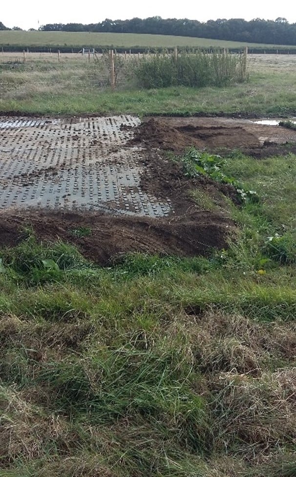 A close up of trackway sealed with topsoil on a field