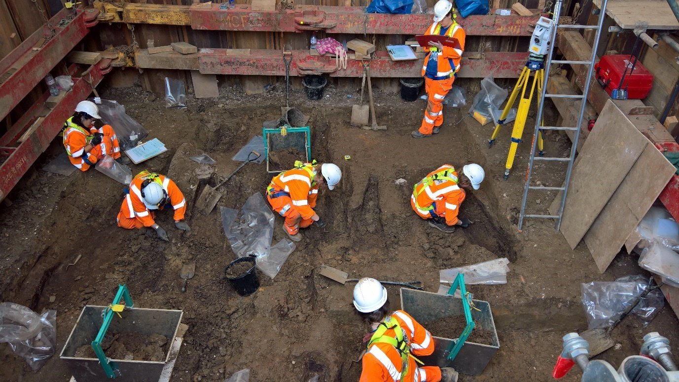 Picture of six workers undertaking a manual archaeological  investigation  